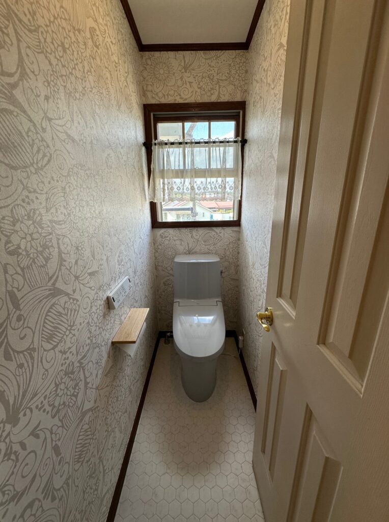 モダンな柄のクロスがおしゃれなリフォーム後のトイレ